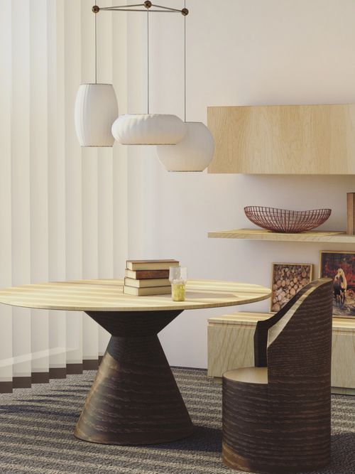 Foto von einem Wohnzimmer mit rundem Tisch, wo Bücher oben sind.