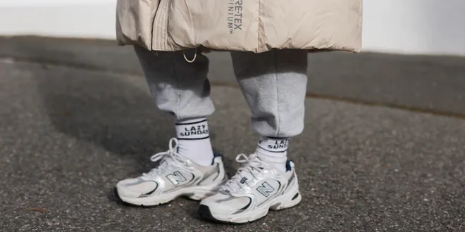 Elise Soho wearing Samsoe Samsoe beige jacket, Hey Soho grey pants, Hey Soho socks and New Balance white sneakers on October 16, 2021 in Hamburg, Germany.