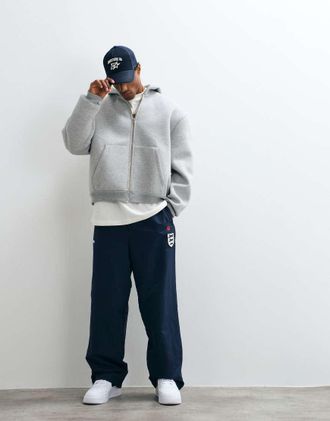 Icecream Joggers blu navy con toppa di cane da corsa