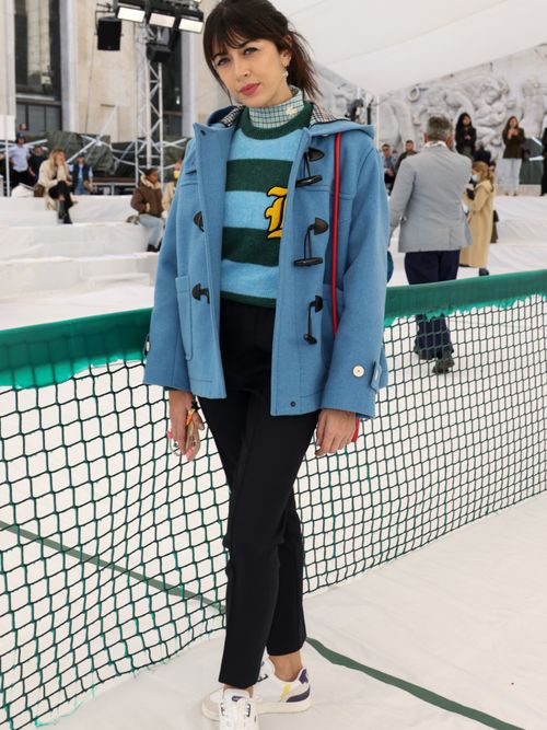 Blue duffle coat with black pants and sneakers