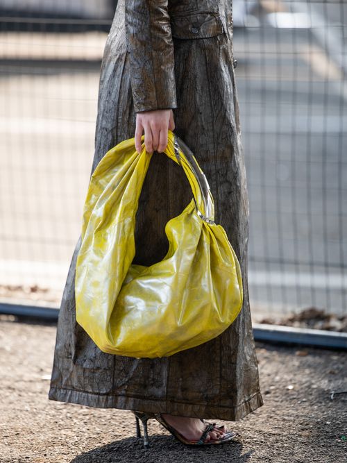 Carla Ginola wears brown snake print coat, yellow bag outside Diesel during the Milan Fashion Week - Womenswear Fall/Winter 2024-2025 on February 21, 2024 in Milan, Italy.