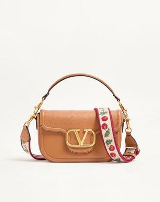 Valentino Garavani Valentino Garavani Alltime shoulder bag in grainy calfskin with Cherryfic embroidered ribbon shoulder strap. Wo