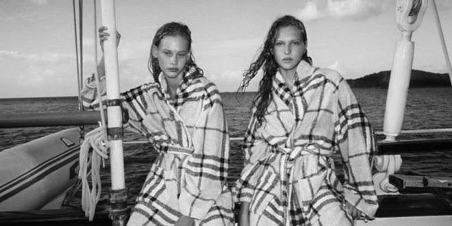 Two models wear check-motif cotton robes by Burberry.