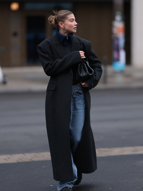 Sophia Geiss trägt einen schwarzen Mantel, blaue Jeans und dunkelblauen Pullover in Berlin.