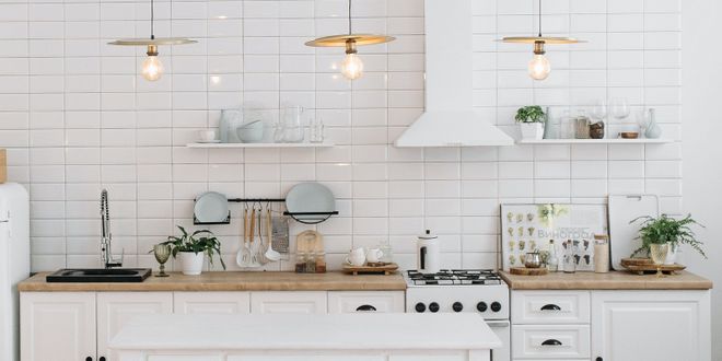 Weiße Küche im Landhausstil mit einer weißen Kücheninsel.