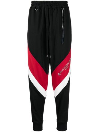 MASTERMIND WORLD logo-print stripe-detailing track pants - men - Polyester/Polyester - L - Black