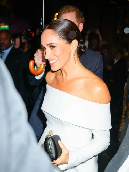 Megan Markle wears a white off-the-shoulder top