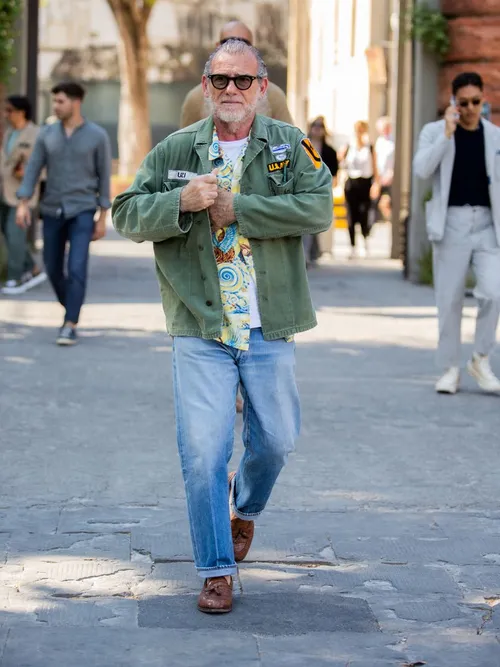 Alessandro Squarzi wears an army jacket with jeans and loafers