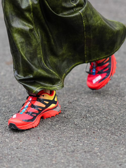 Close-up detail view of red Salomon sneakers shoes, outside Aeron, during the Copenhagen Fashion Week AW24 on January 30, 2024 in Copenhagen, Denmark.