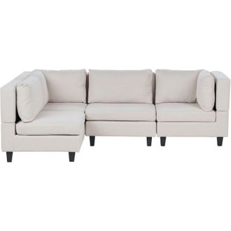Beliani Divano componibile a 4 posti imbottito in tessuto beige chiaro gambe nere lato destro Unstad