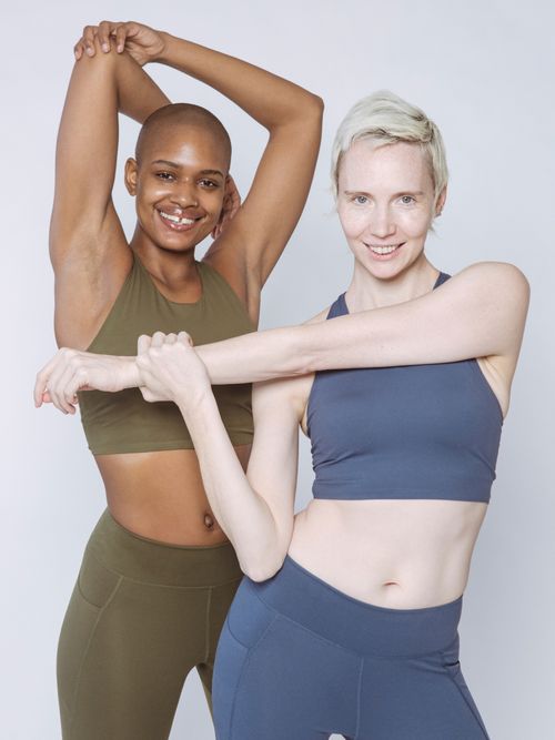 Zwei Damen in Sportmode die gerade Dehnübungen machen