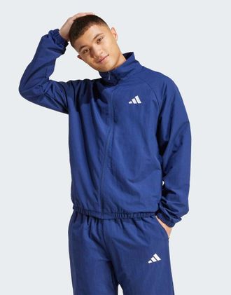 adidas Essential - Giacca a vento blu scuro e bianca con logo piccolo