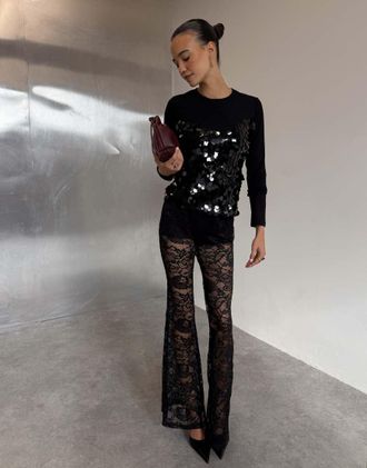 Never Fully Dressed pantaloni svasati neri con shorts interni in pizzo-Nero