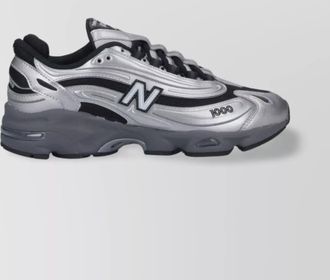 New Balance low top sneakers with mesh panels and reflective accents