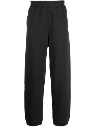St&uuml;ssy logo-embroidered tapered track pants - unisex - Cotton/Polyester - M - Black