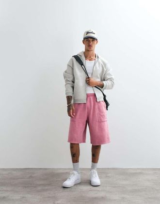 Nike Street - Pantaloncini rosa pallido con tasca sul retro e logo