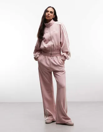 Cernucci Pantaloni sportivi a fondo ampio rosa chiaro con fettuccia laterale in coordinato