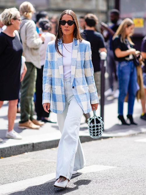 woman walking the city in blazer and trousers