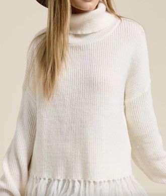 Mimosa Fringe Hem Ribbed Turtleneck Sweater In Cream