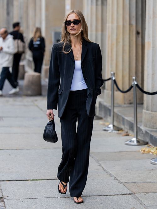 A guest wears a dark blue blazer with dark blue pants