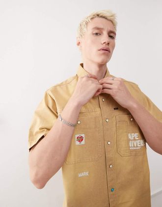 Aape By A Bathing Ape Aape by A Bathing Ape - Camicia a maniche corte stile worker beige con ricami sul retro-Neutro