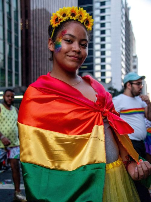 Guest wears a pride flag with flower crown