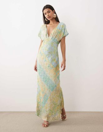 Never Fully Dressed Vestito lungo con scollo a V in sbieco blu e oro con stampa