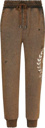 Dolce & Gabbana logo-print ripped track pants - men - Cotton/Nylon - 50 - Brown