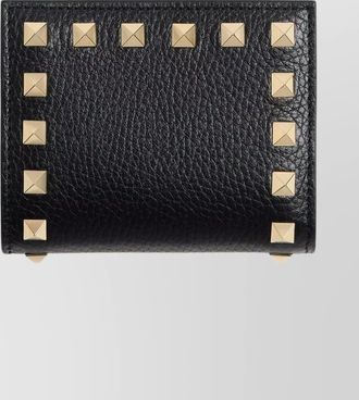Valentino Garavani compact wallet featuring studded texture