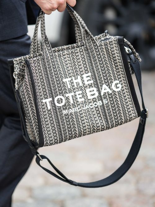 A guest carries a Marc Jacobs tote bag